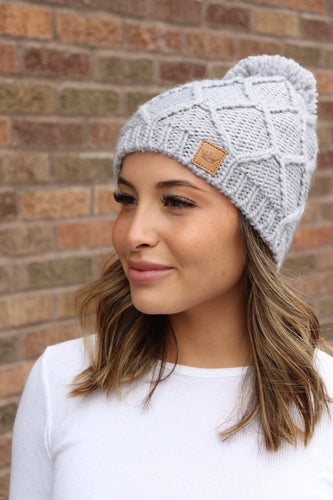 Grey knit hat with pom
